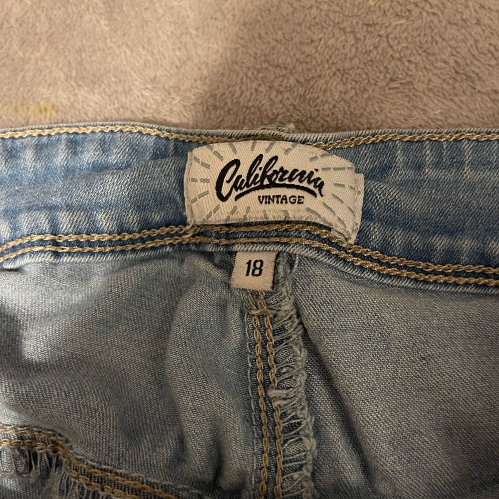 size 18 jeans, light blue with rips in them.